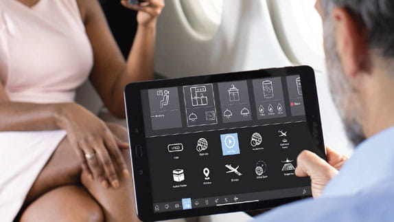 A man interacts with a customized aircraft tablet