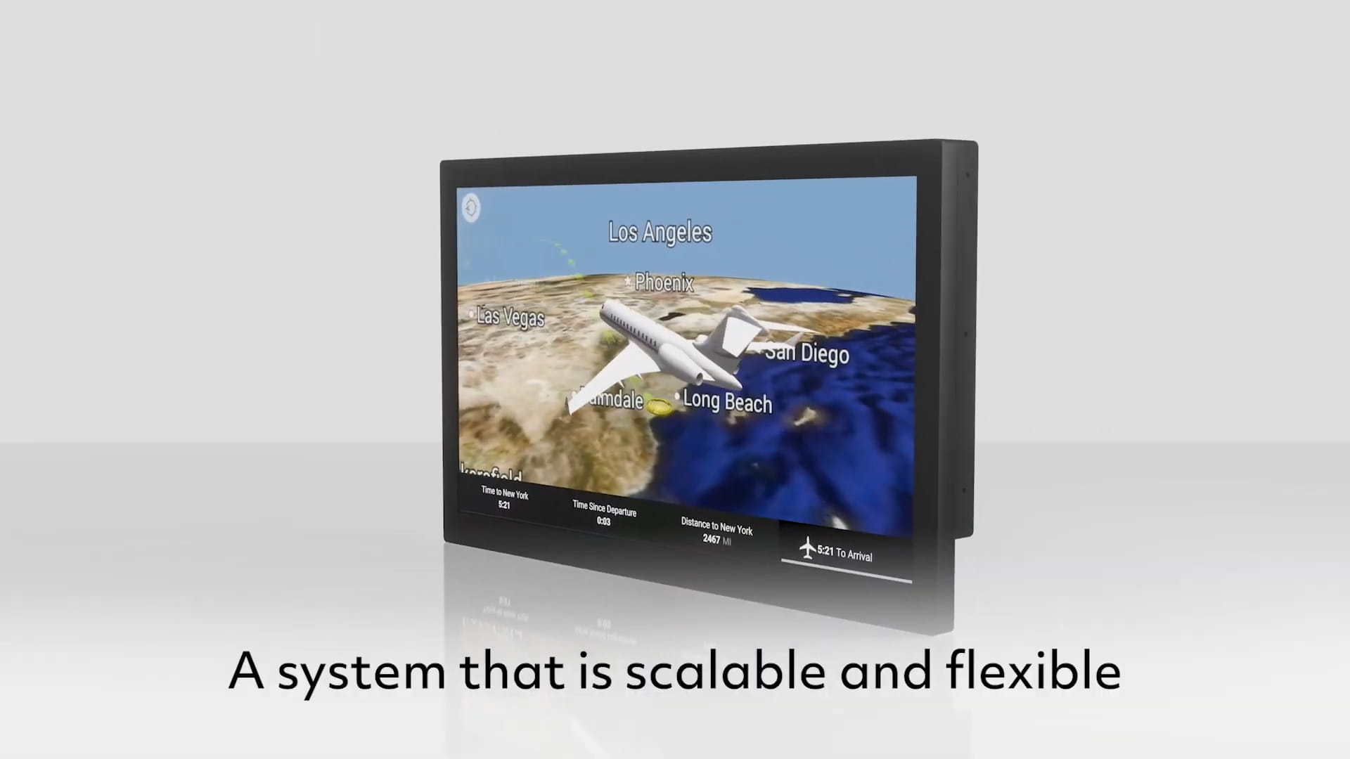 A video screen is shown with a computer-generated simulation of a business jet flying over a body of water approaching land