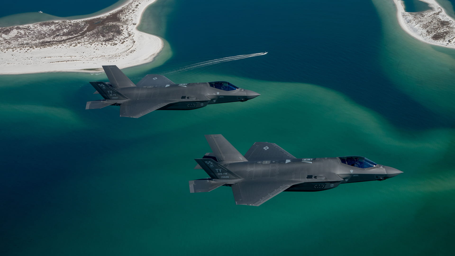 Two F-35s in flight over islands