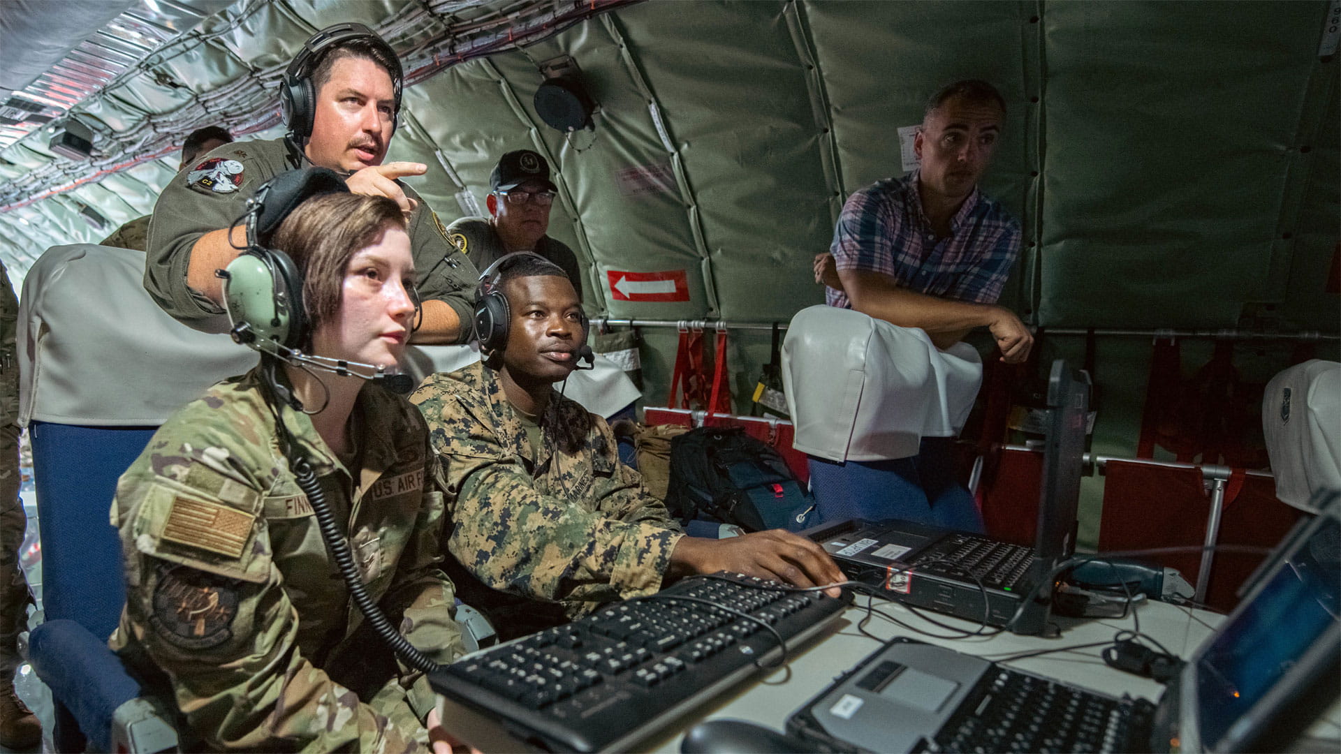 U.S. Air Force and U.S. Marine Corps servicemembers aboard the KC-135 Stratotanker