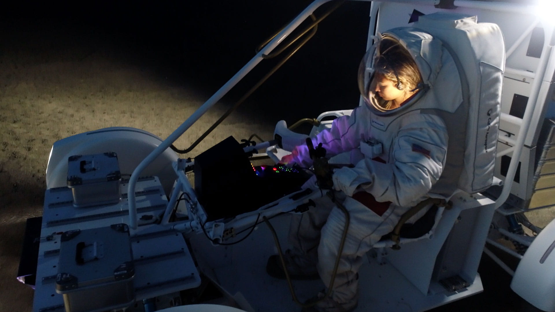 A female astronaut in a lunar terrain vehicle