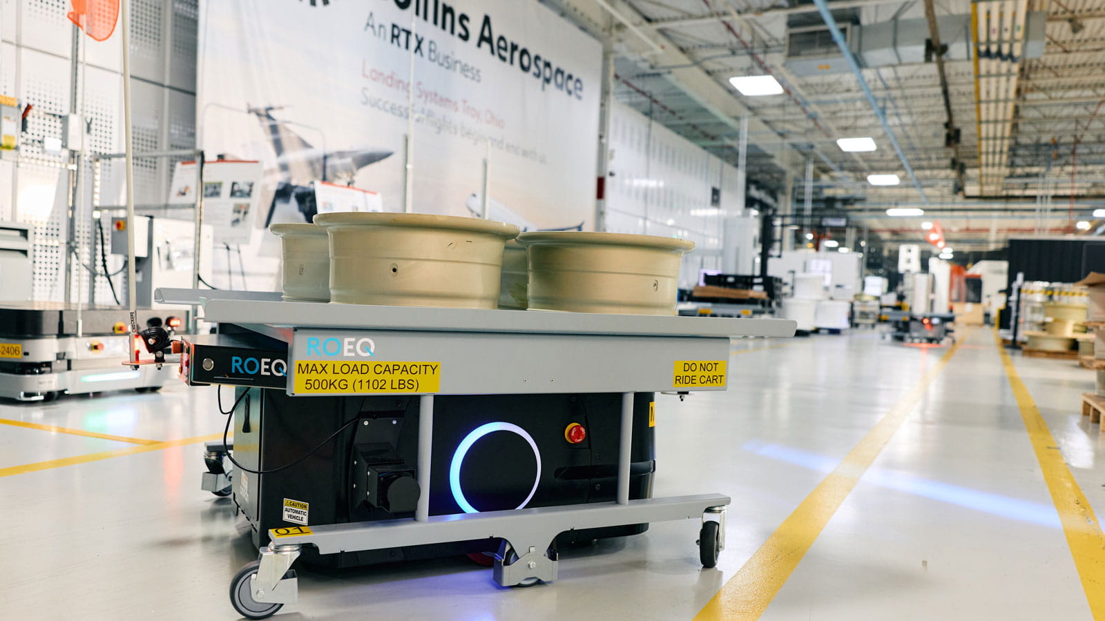 An autonomous material robot, or AMR, moves raw forging to the wheel machining cell.