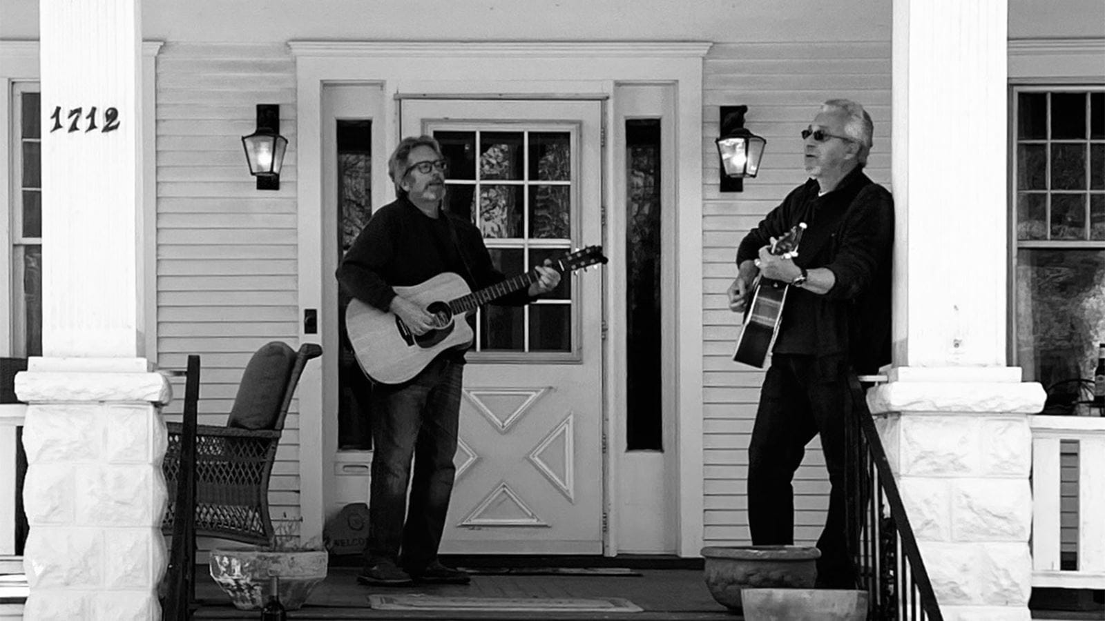 Matt Lightcap and John Horowy playing music for their neighbors in Rockford, Ill.