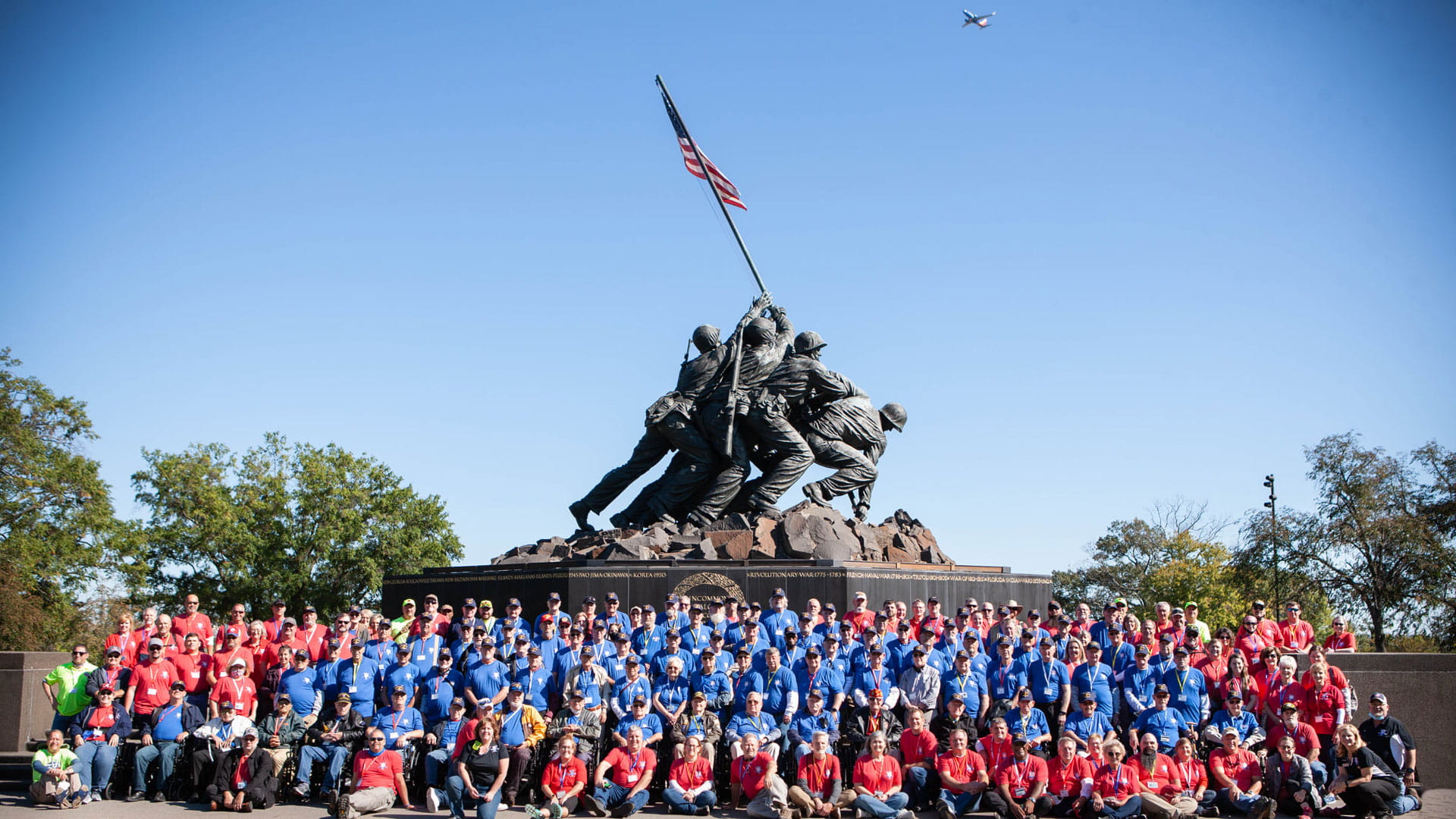 Group shot with memorial soldier statue