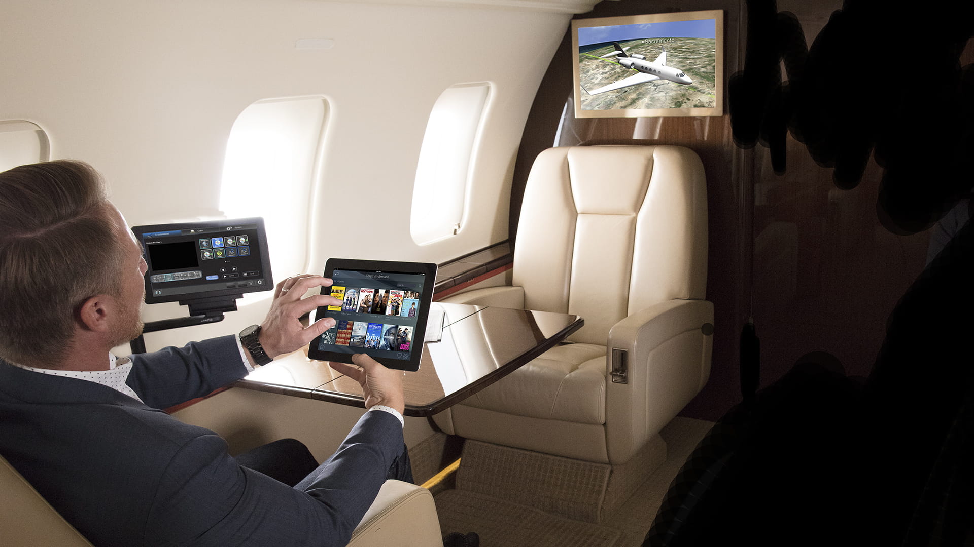 Business man in private jet using tablet