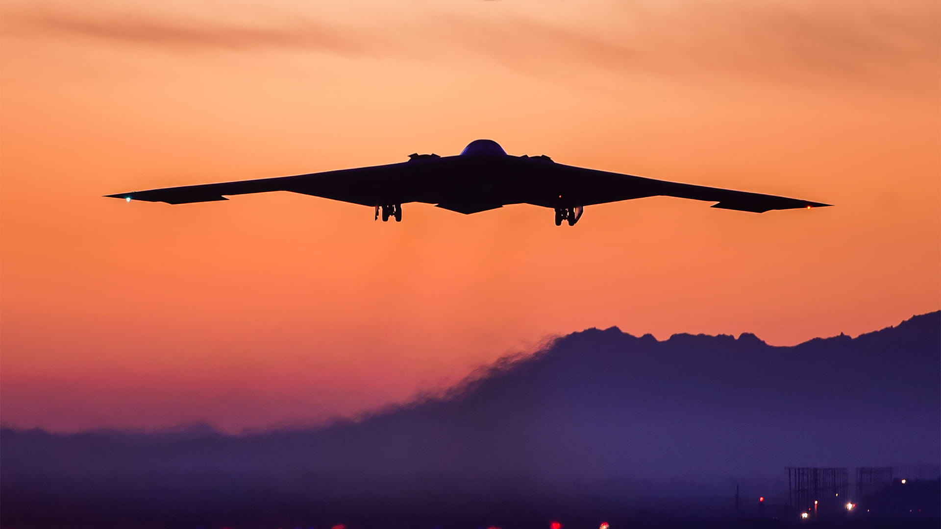 Military plane in flight at dusk
