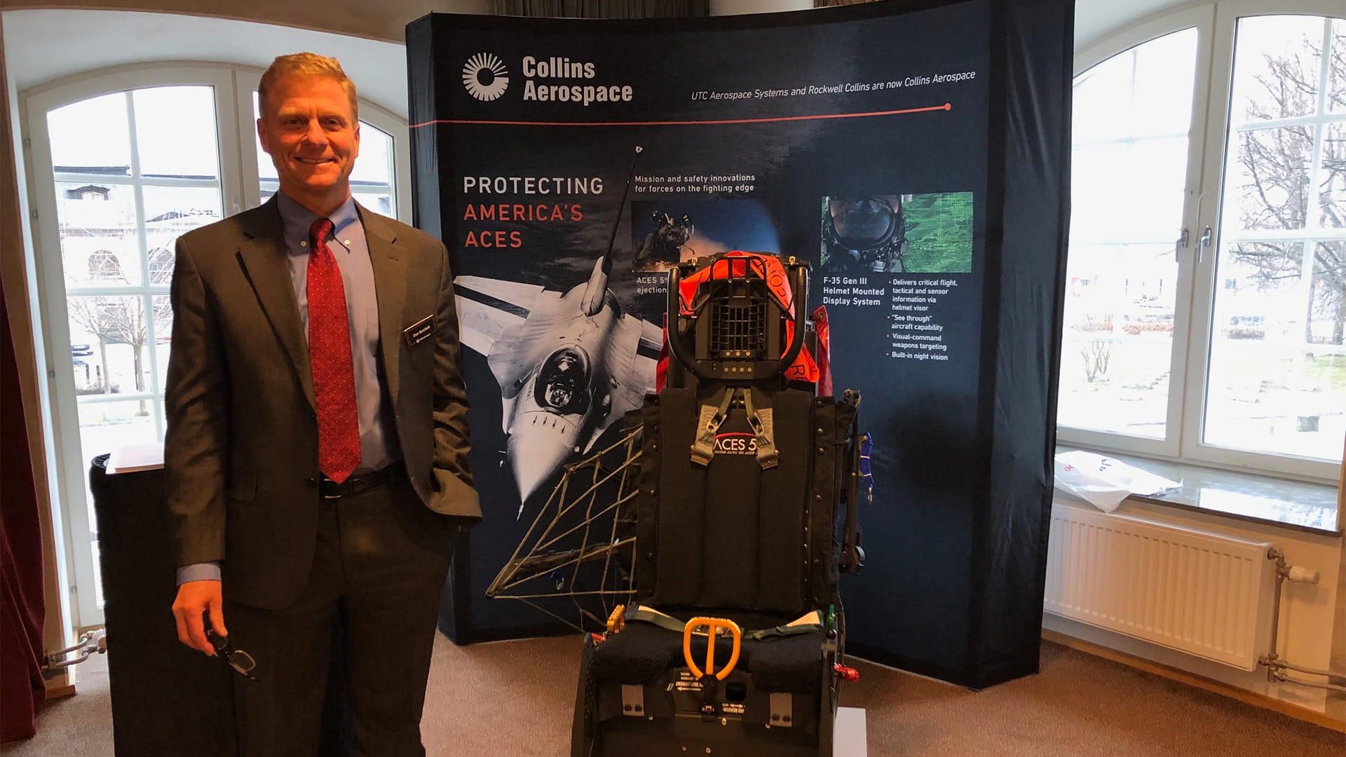 Man standing next to ACES 5 Ejection Seat