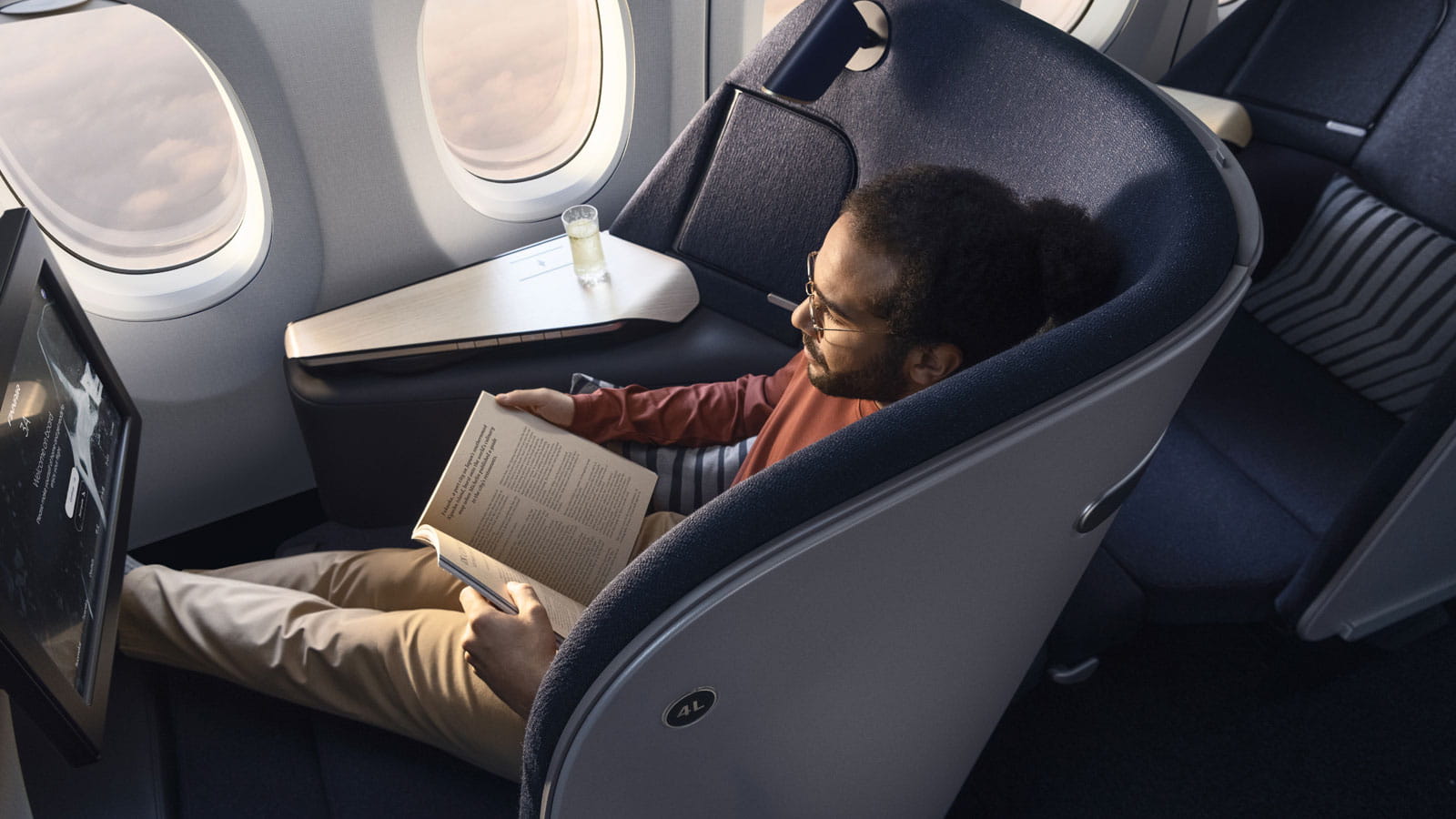 A man sits in a high end aircraft seat