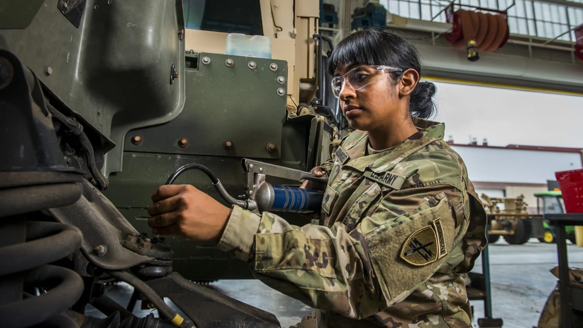 Army mechanic performing maintenance