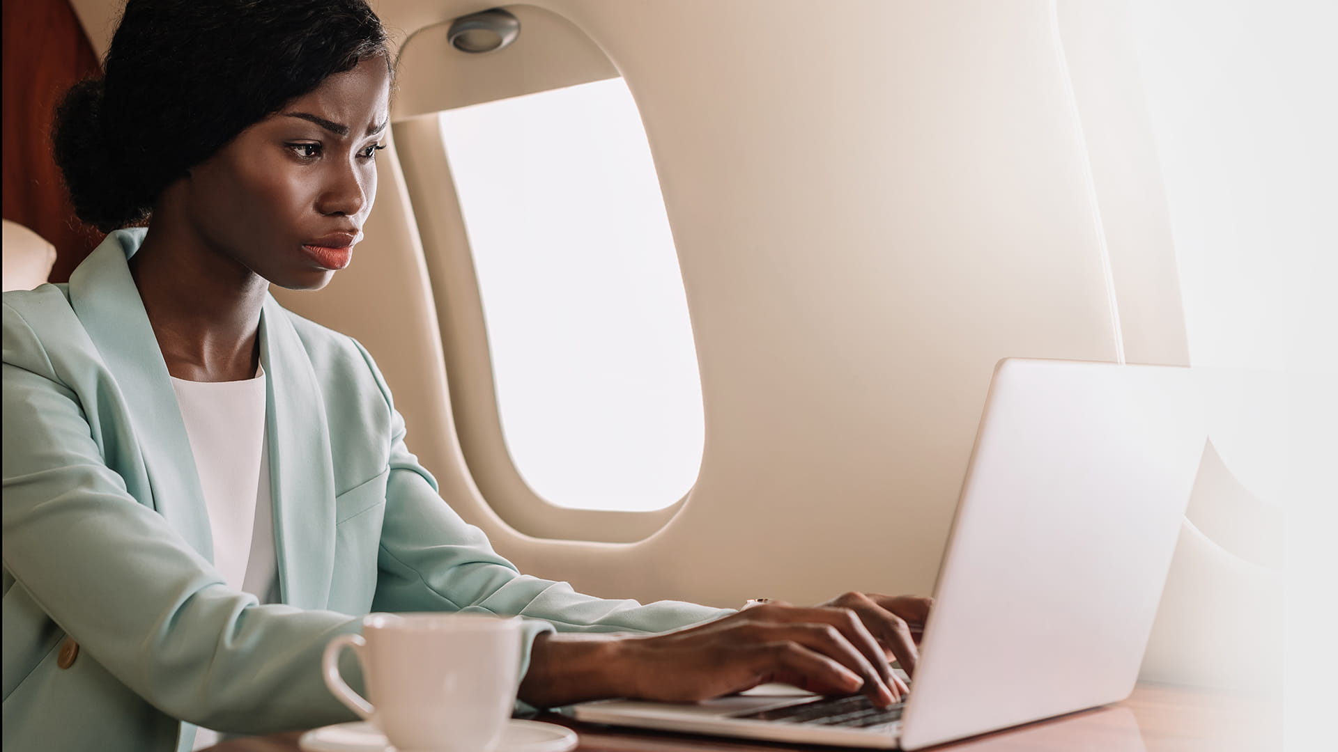 Woman using laptop on jet