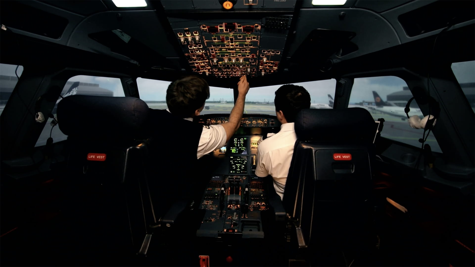 Two pilots in a commercial aircraft flight deck