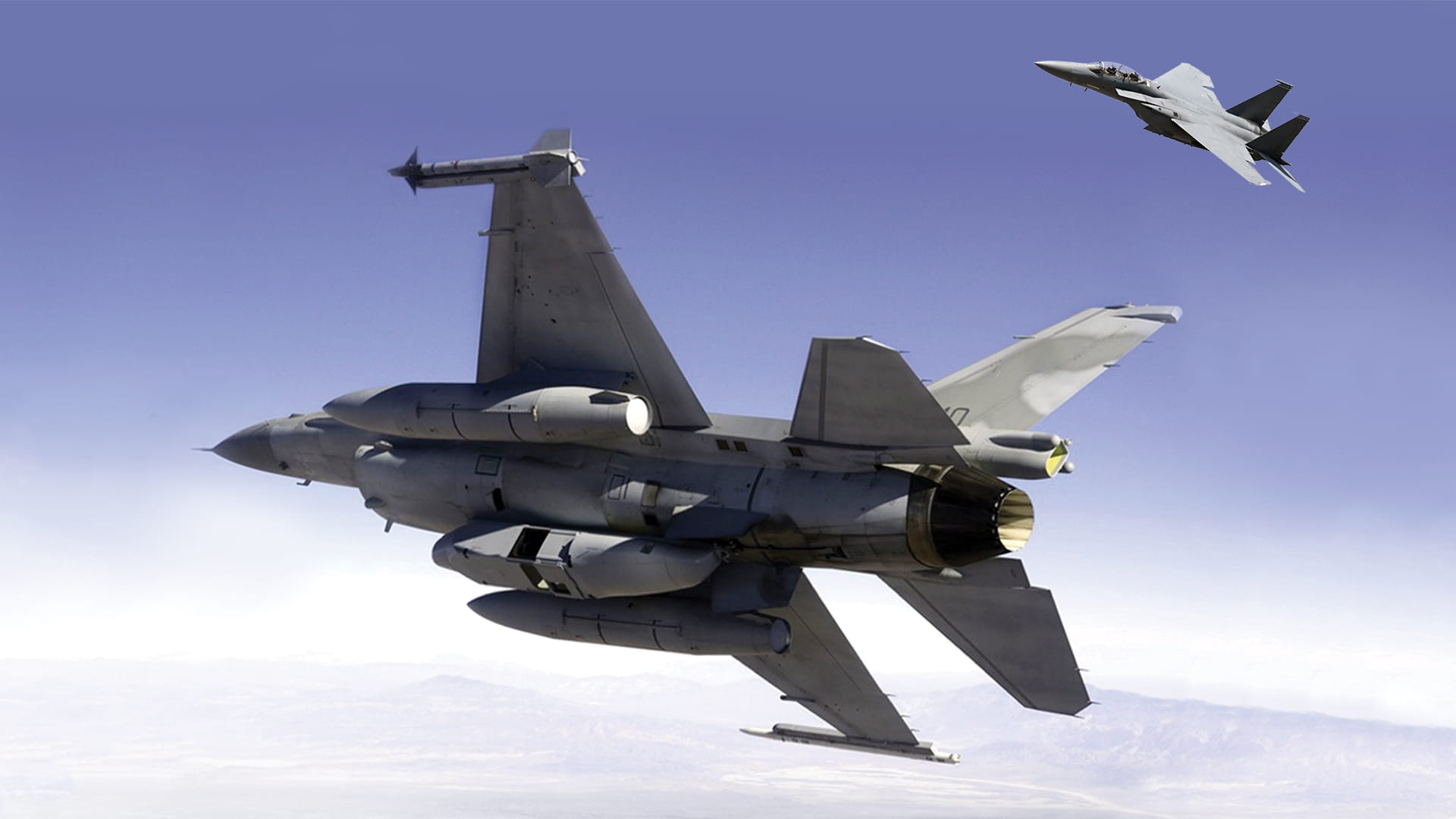 F-15 and F-16 fighter jets soaring