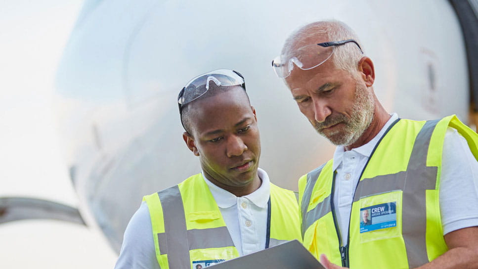 Aircraft personnel overlooking plans