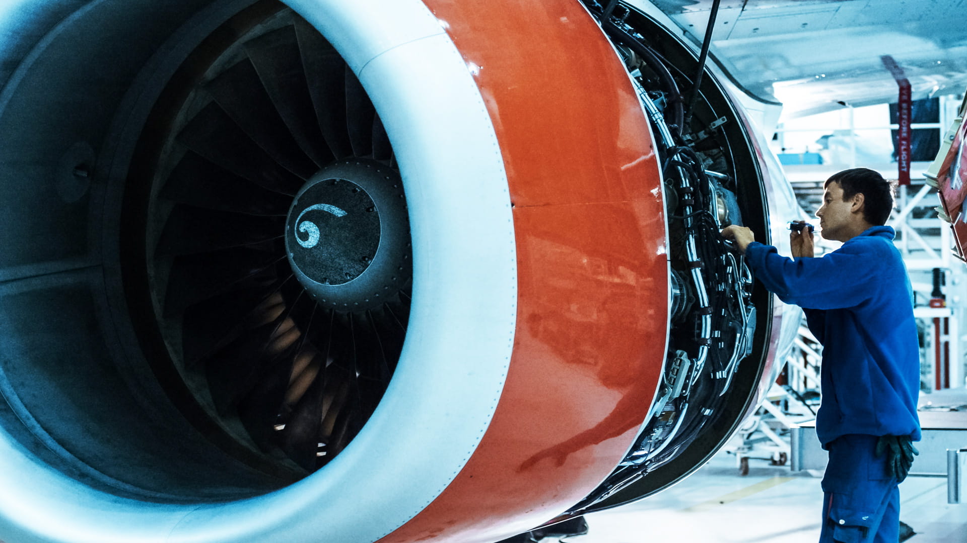 A mechanic inspecting an airplane engine