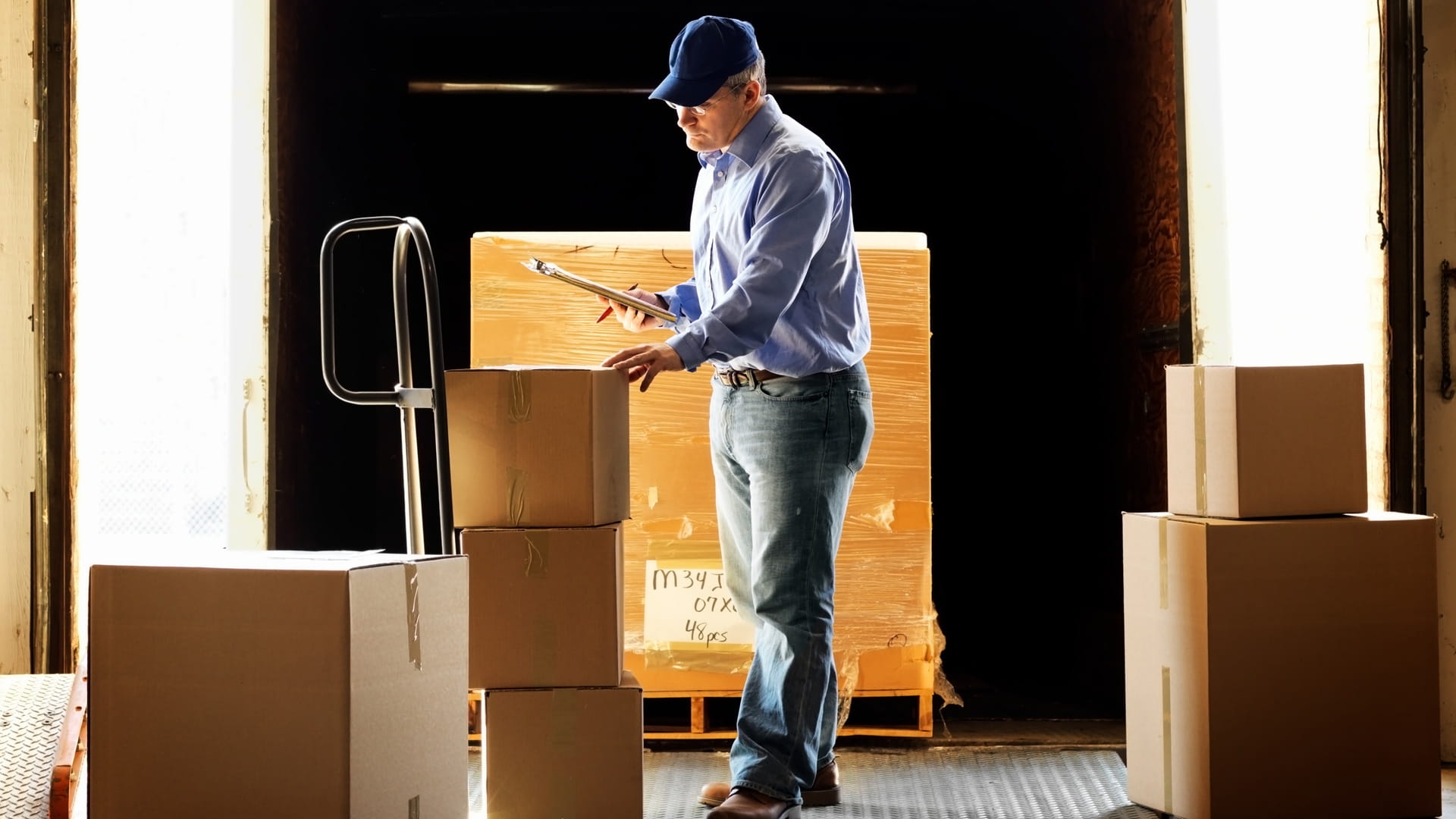 a delivery man looking at packages