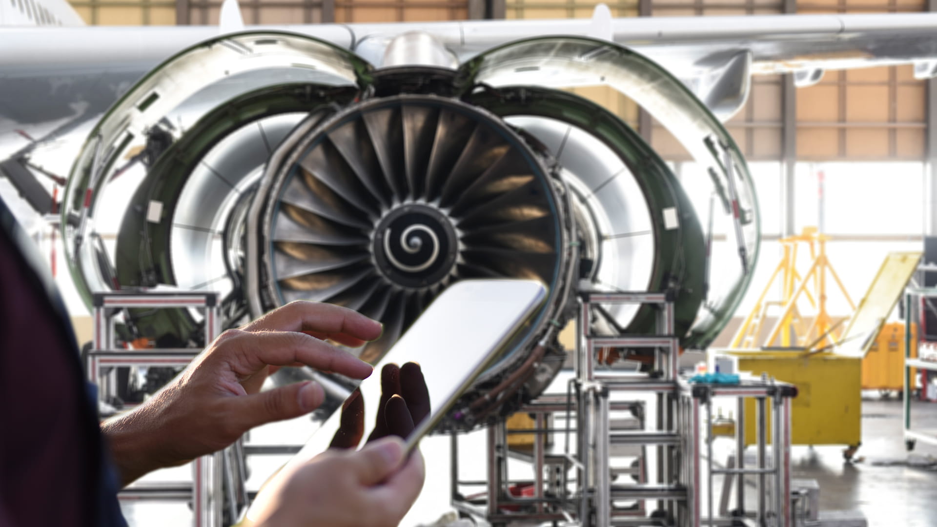 a tech in front of an airplane jet engine