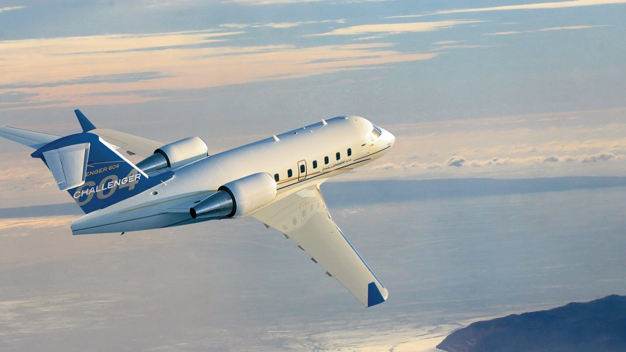 private business jet flying above the ocean