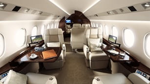 inside private jet are two luxury leather chairs