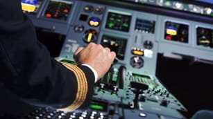 a captain with his hand on the thrust lever