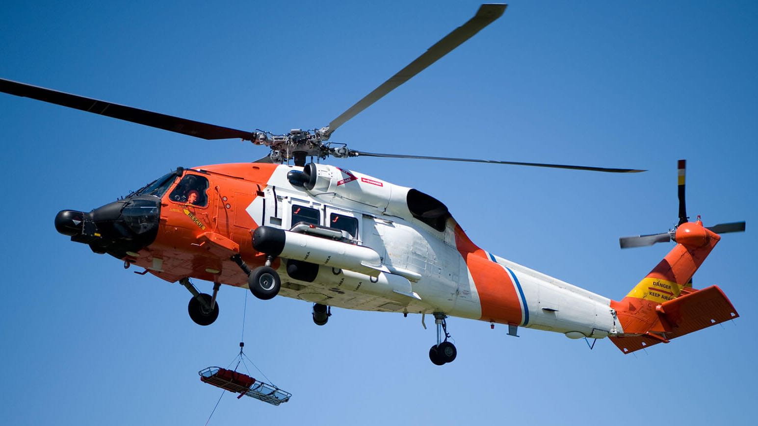 helicopter rescue hoist in use in flight