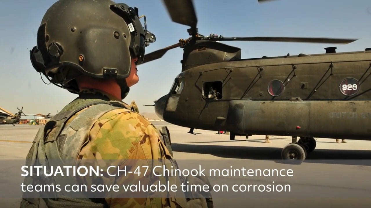 A soldier standing in front of a CH-47 Chinook helicopter