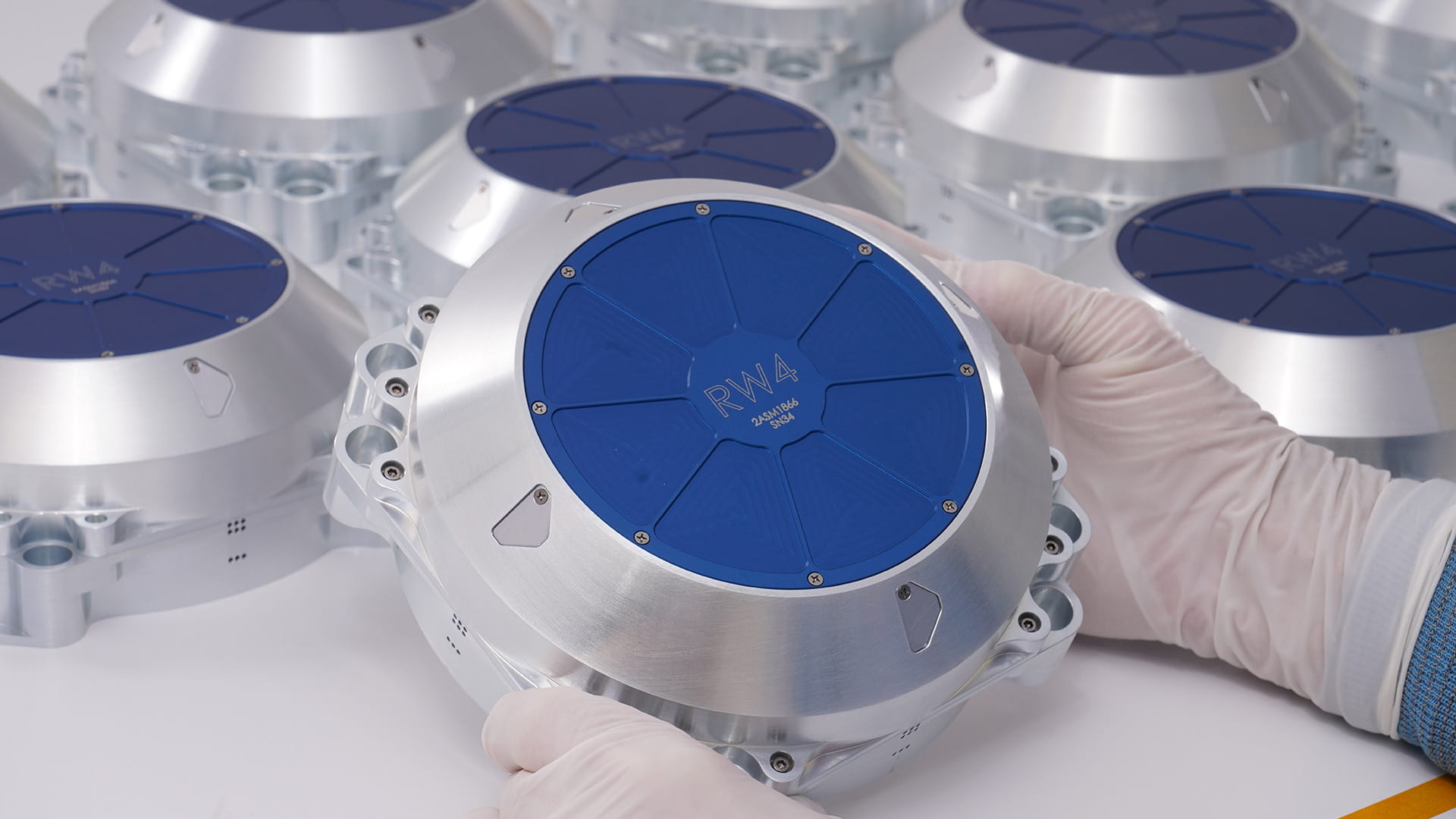 Hands holding a reaction wheel