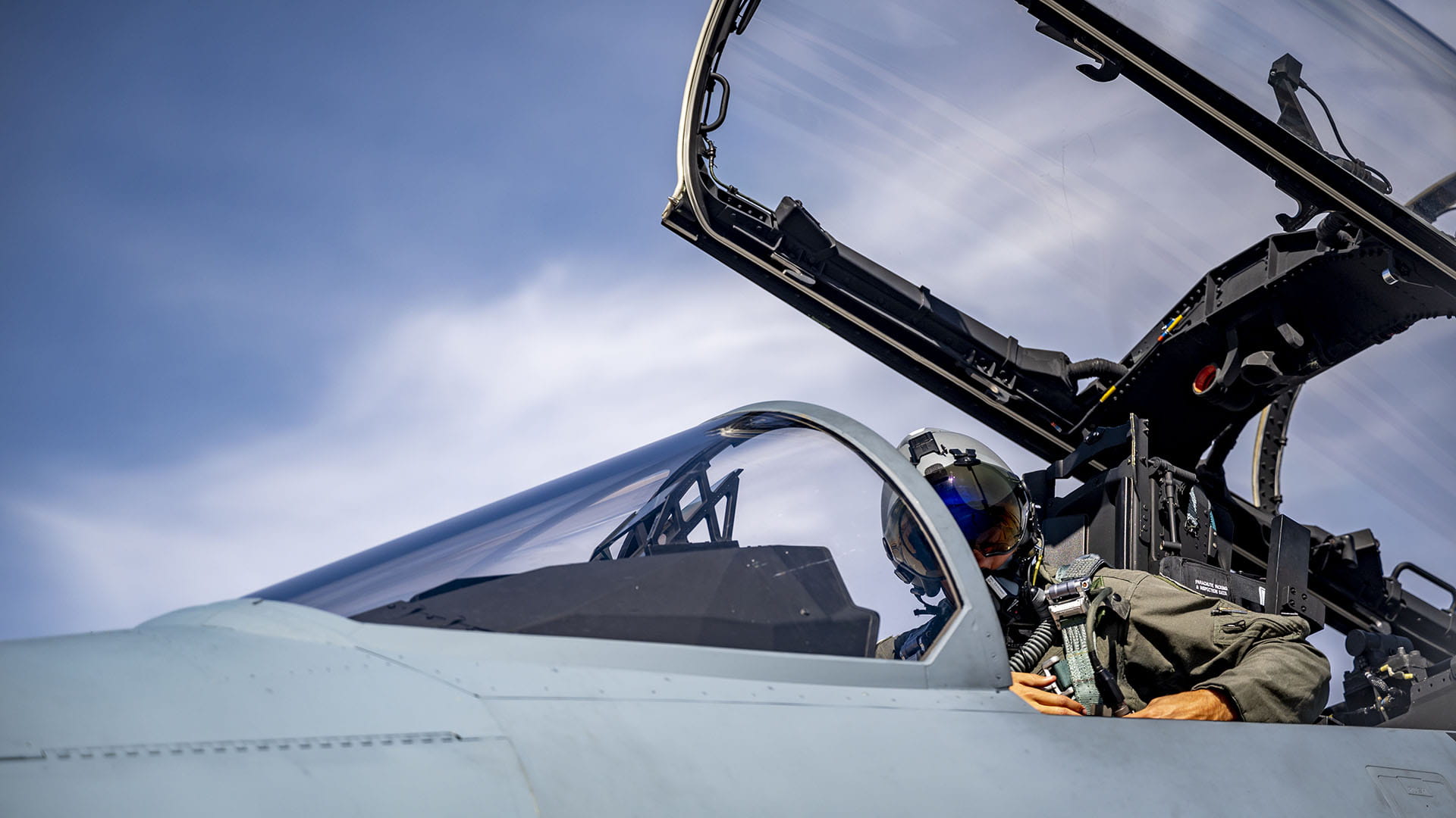 close up of pilot in F-15 with cowl open