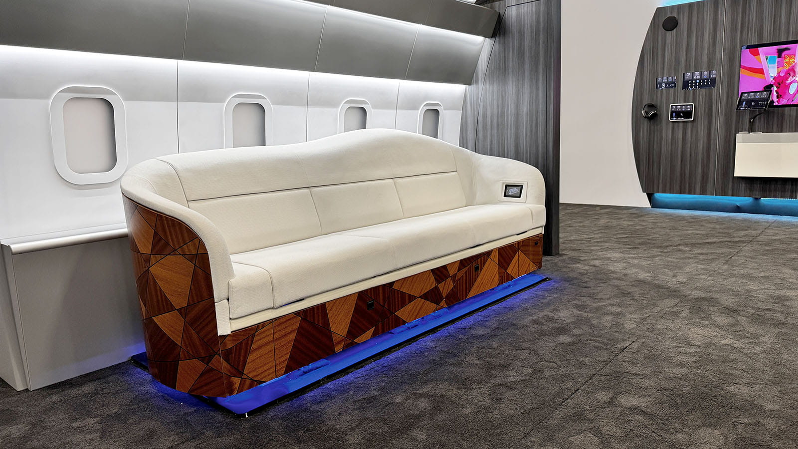 aircraft couch on display at a Collins tradeshow booth