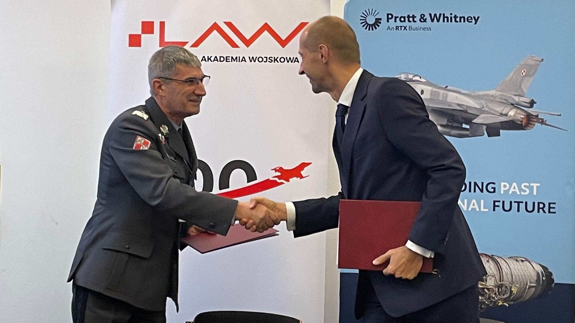 two men shaking hands holding contracts 