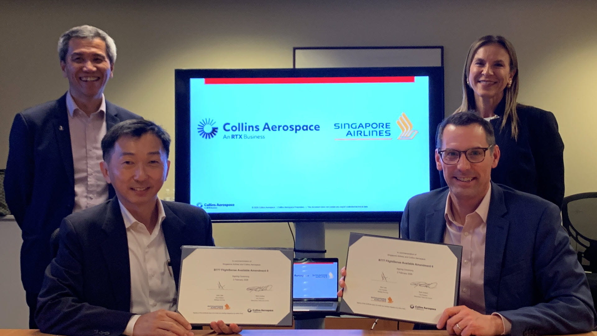 Employees of Singapore Airlines and Collins Aerospace at a signing ceremony