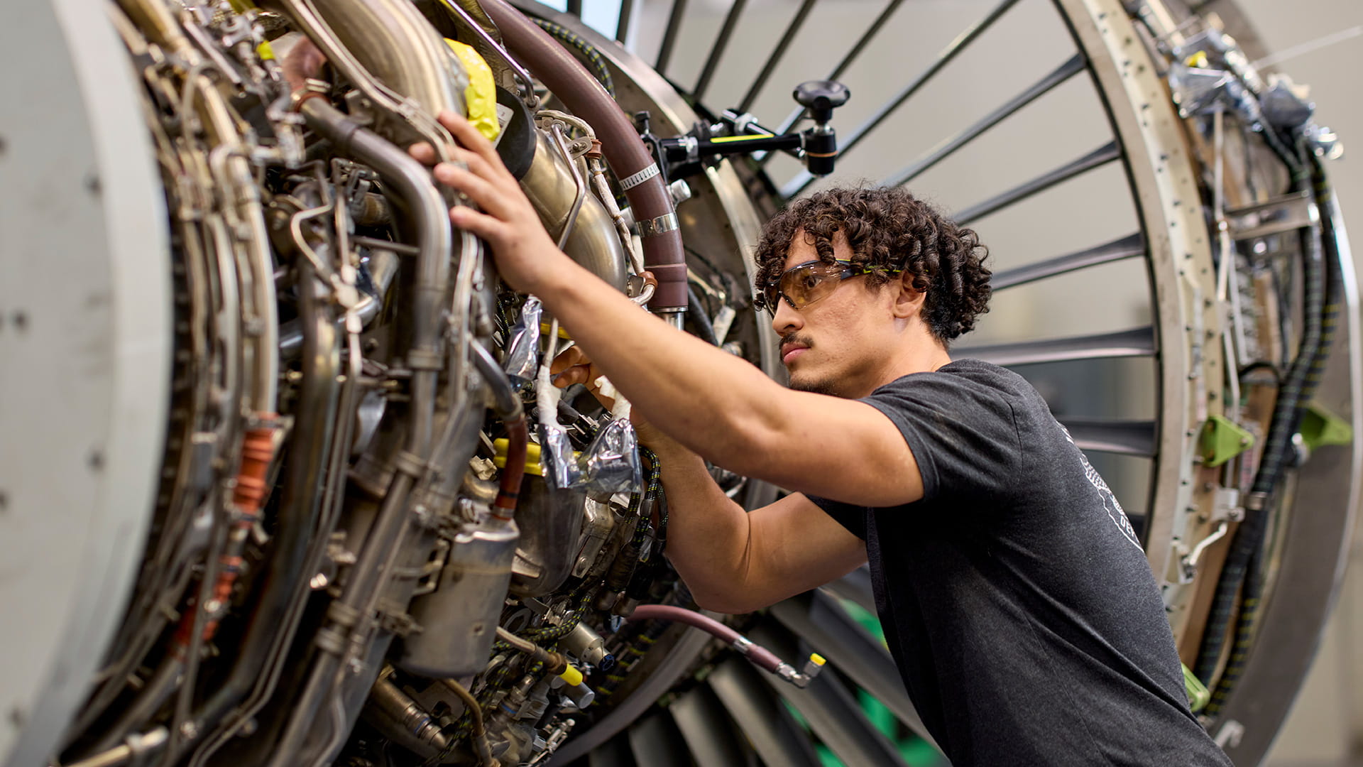 A technician working on an aircraft engine