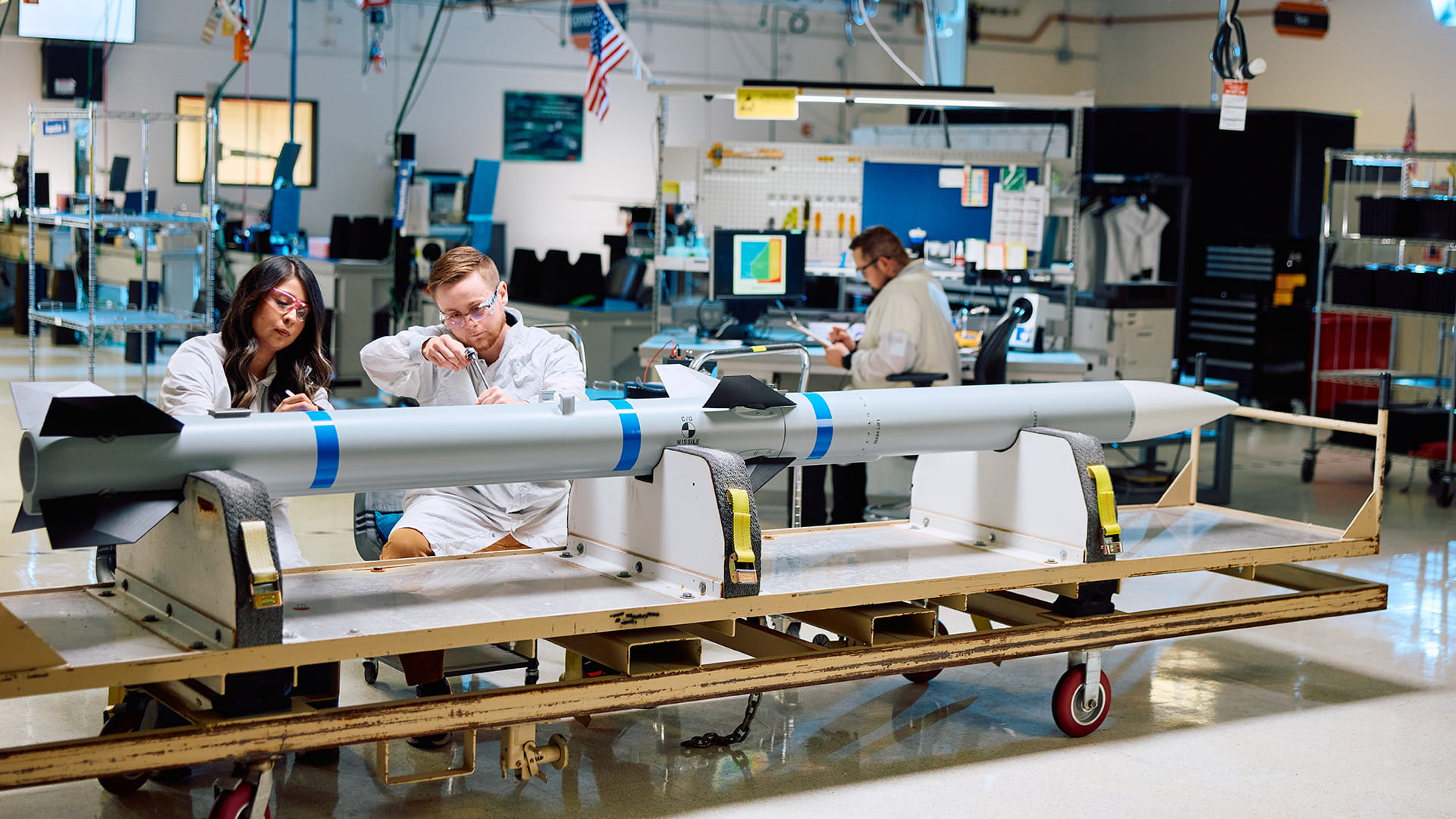 Two technicians working on an AMRAAM missile