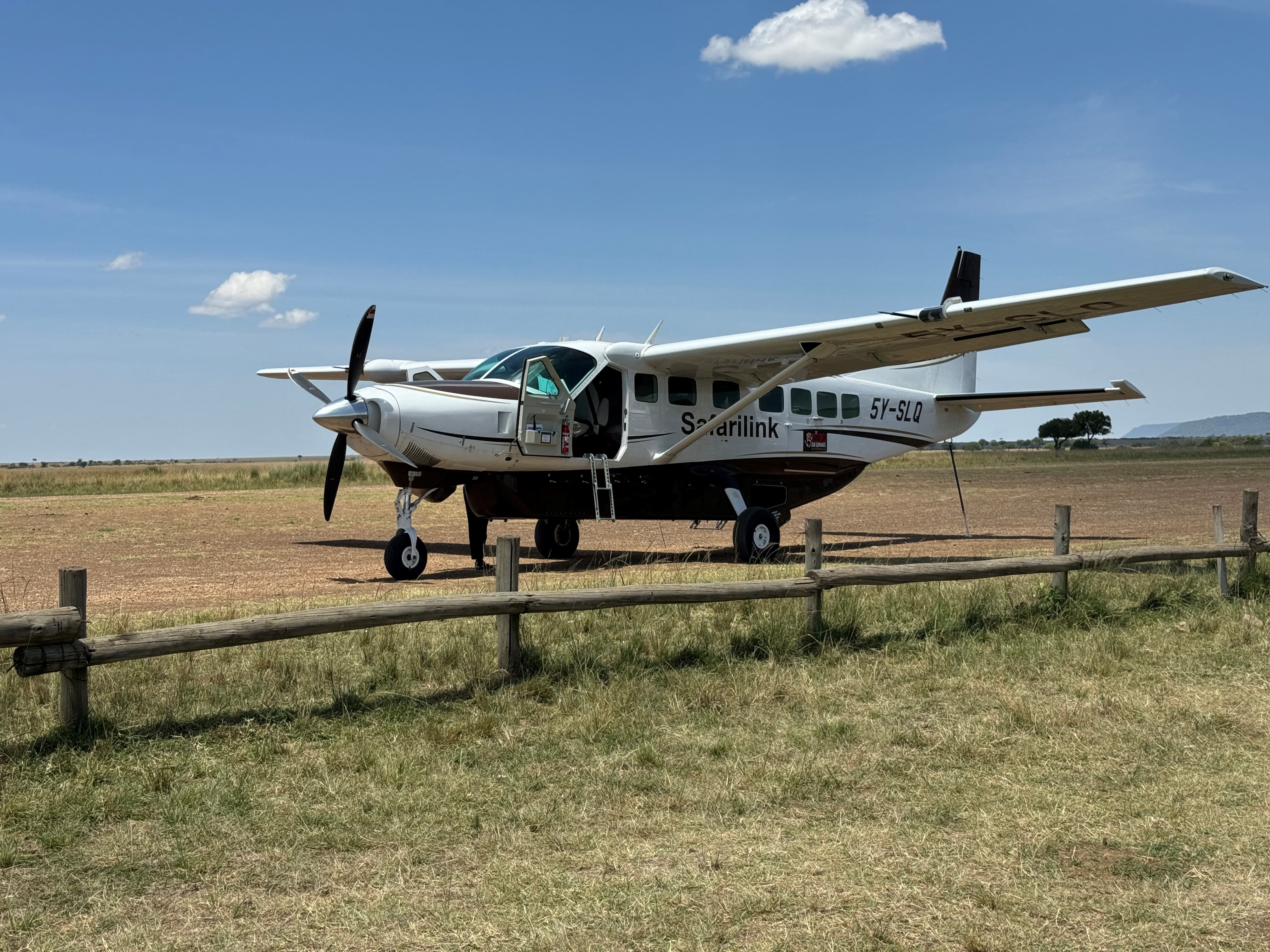 A small turboprop engine plane sitting in a field