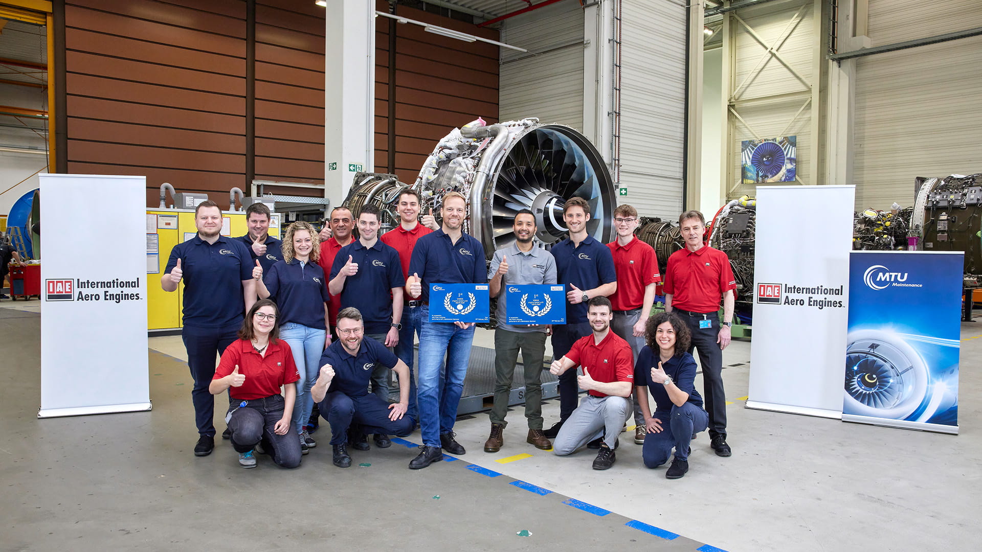 IAE team in front of test engine