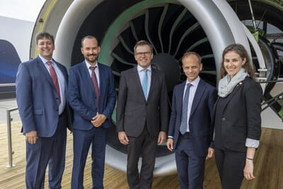 People standing in front of an engine