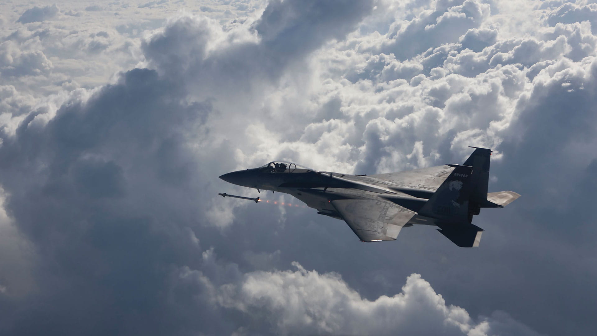 A fighter jet fires an AIM-9X Sidewinder missile
