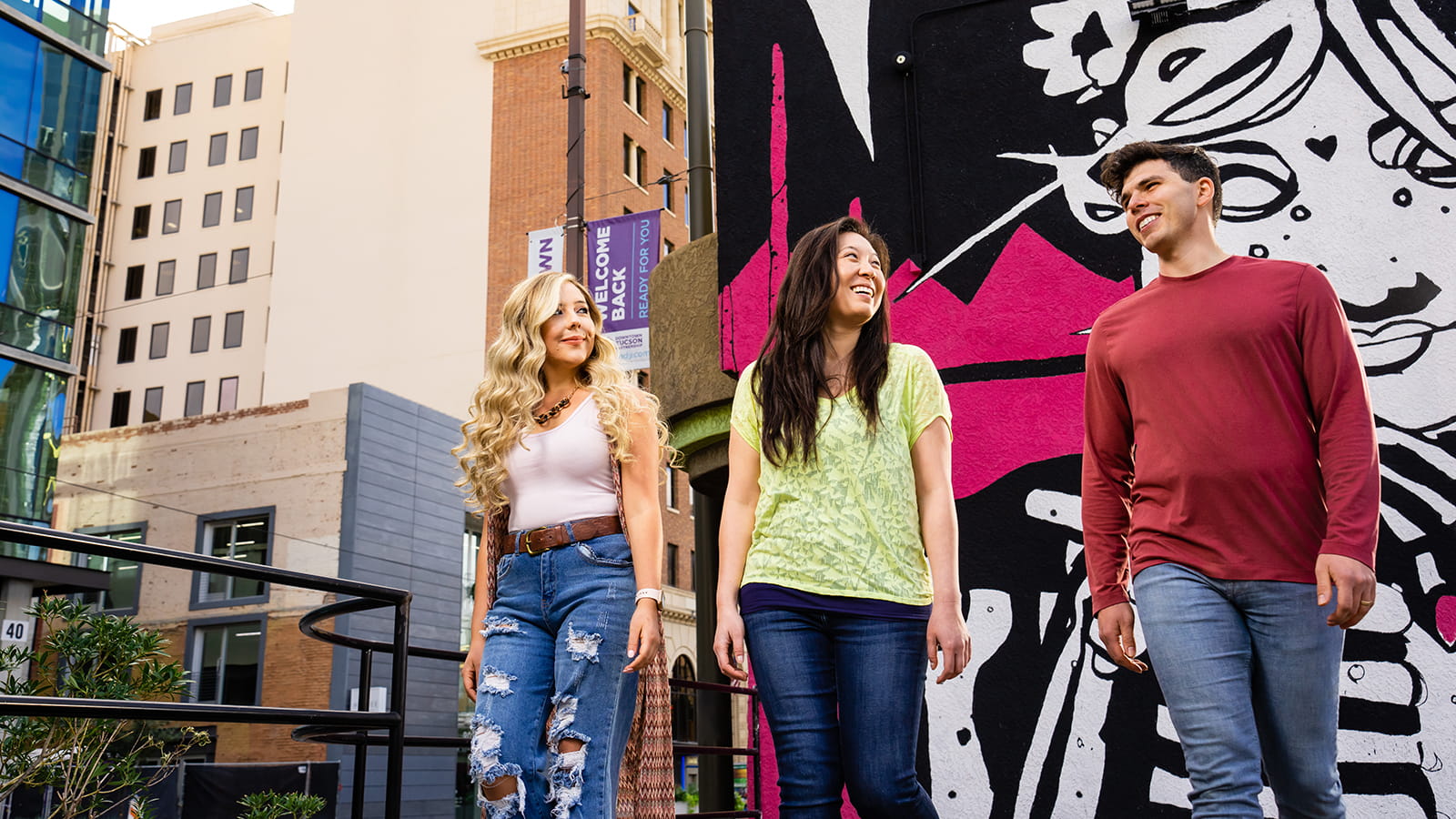A group of people walk through downtown Tucson.