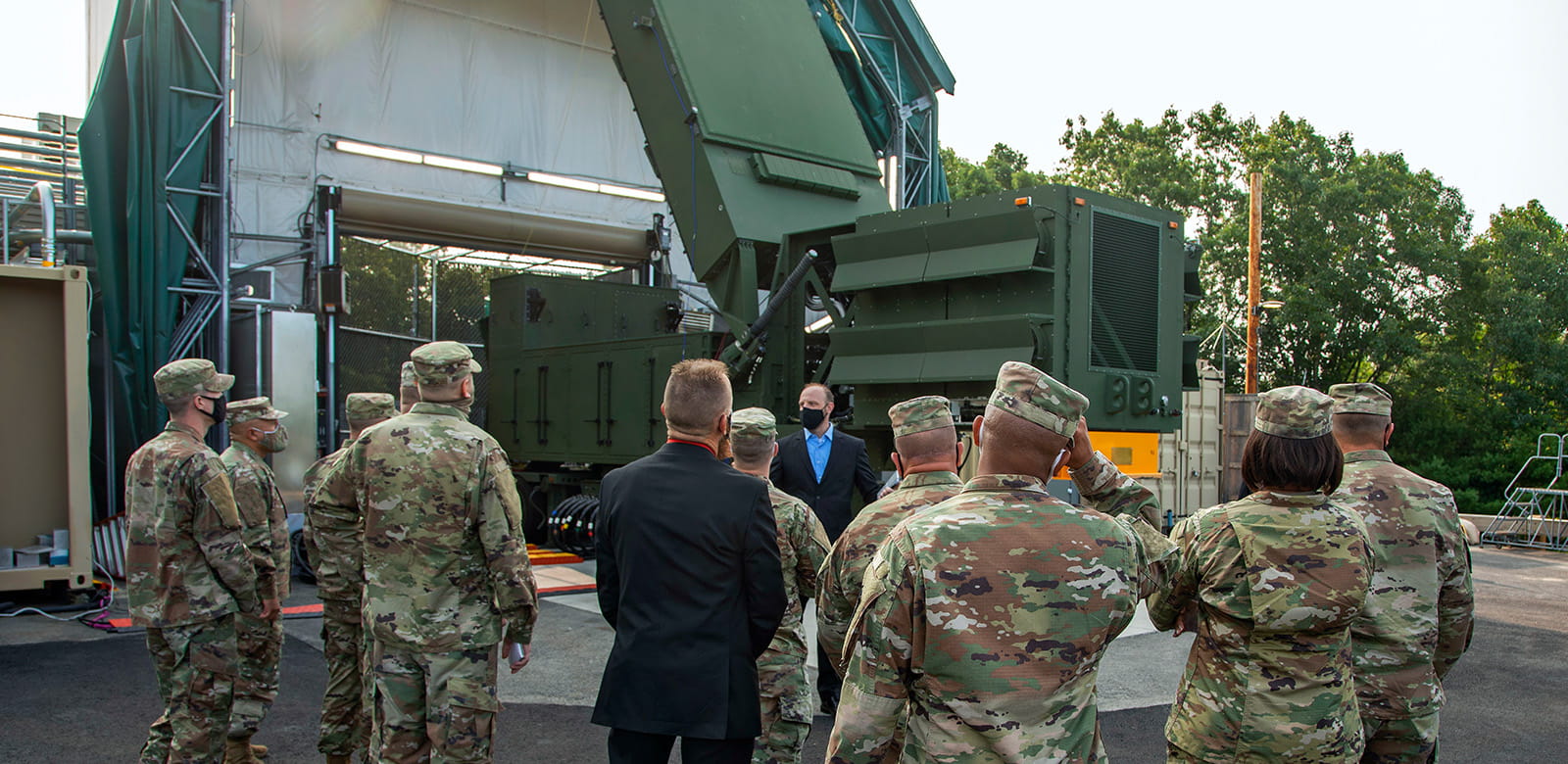 Soldiers stand by a radar at a test facility.