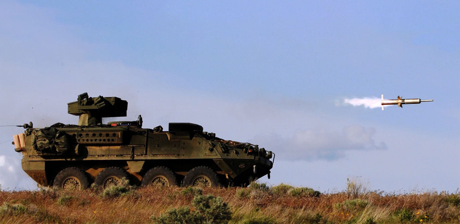Tank with a Tow weapon launcher shooting a missile