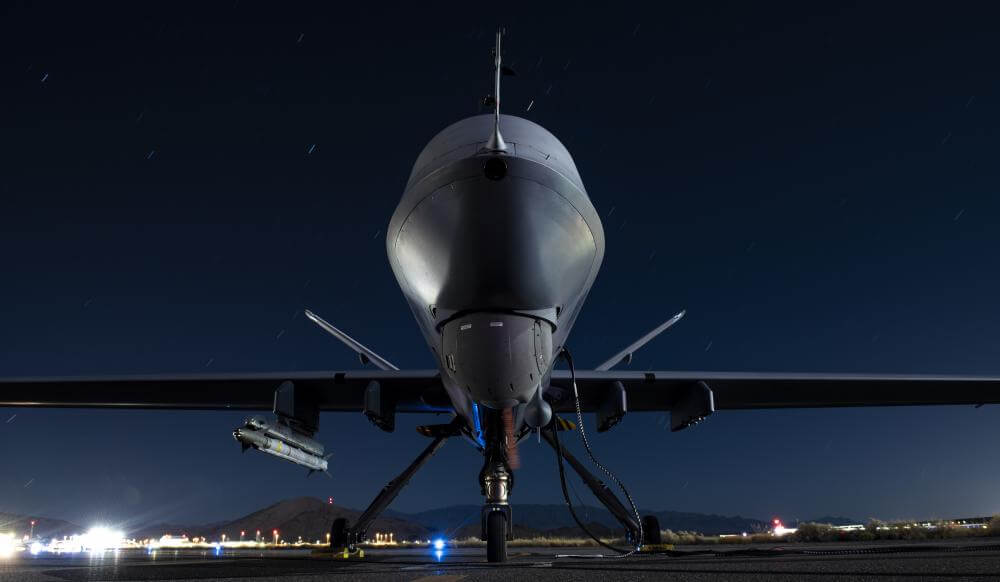 A U.S. Air Force MQ-9 Reaper armed with an AIM-9X SIDEWINDER missile sits on the tarmac ahead of the Advanced Battle Management System Onramp #2 test. (U.S. Air Force photo by SrA Haley Stevens)
