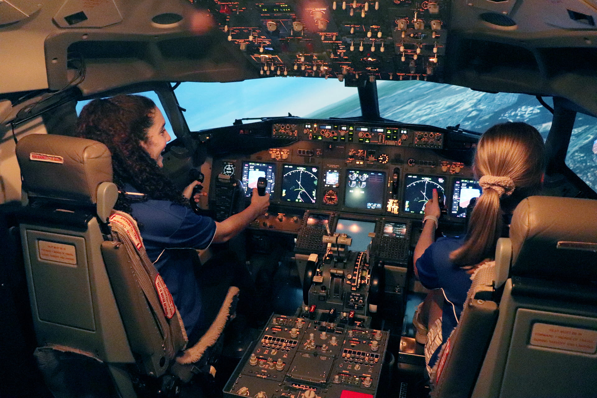 Two Australian students get their first chance at flying an aircraft through flight simulation while taking part in the annual Australian Youth Aerospace Forum in Queensland