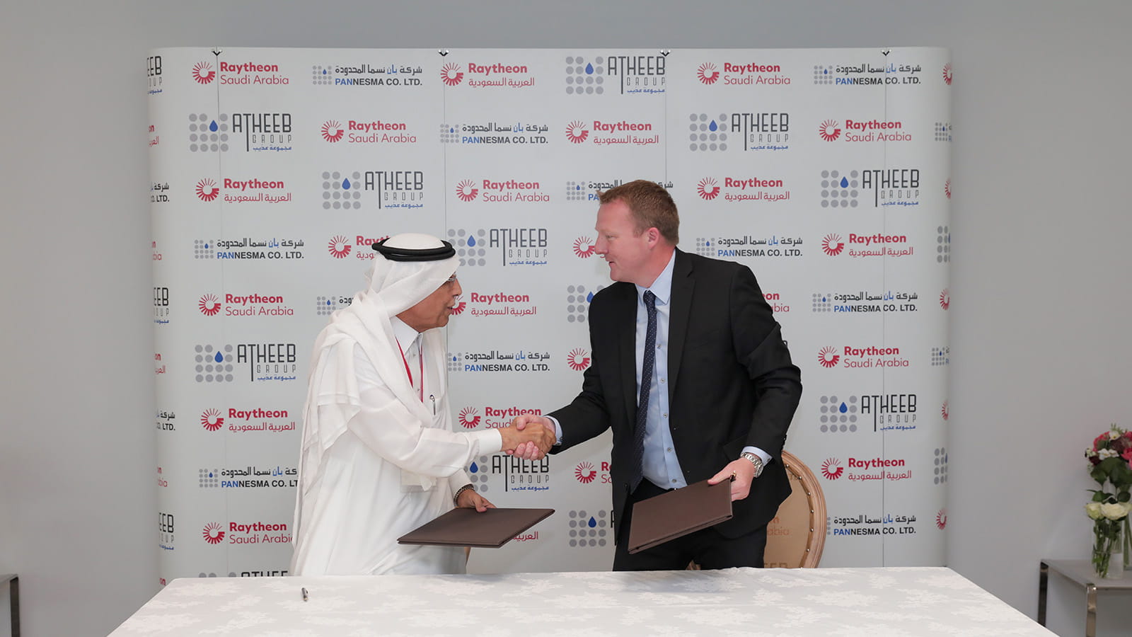 Bryan Barker and Saad O. Al-Baiz shaking hands