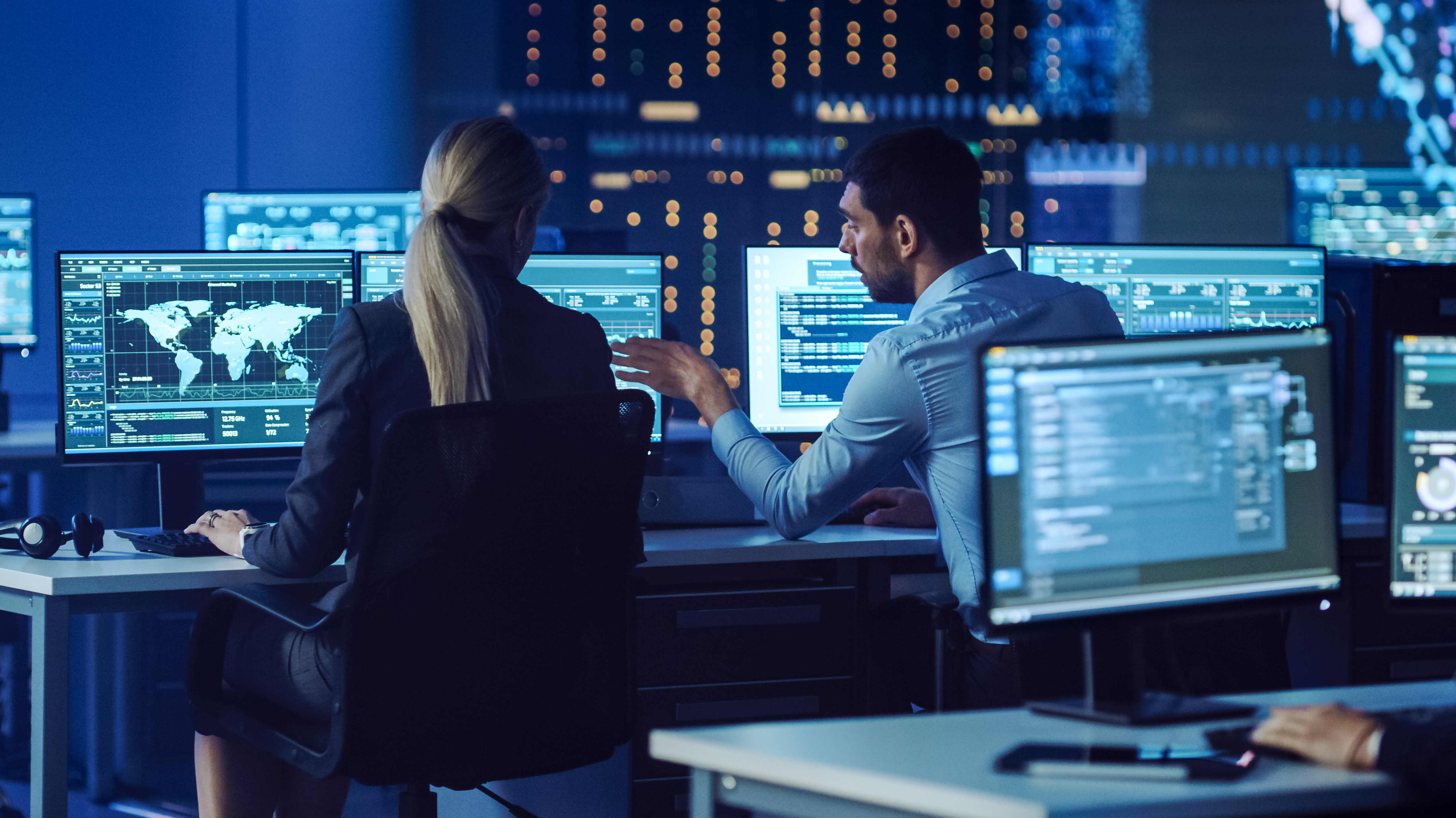 a male and female engineer in a control room