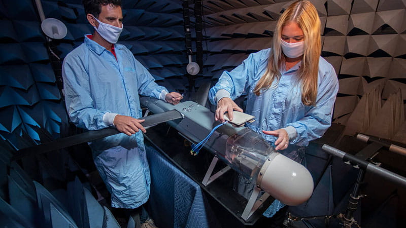 a male and a female technician working on defense system