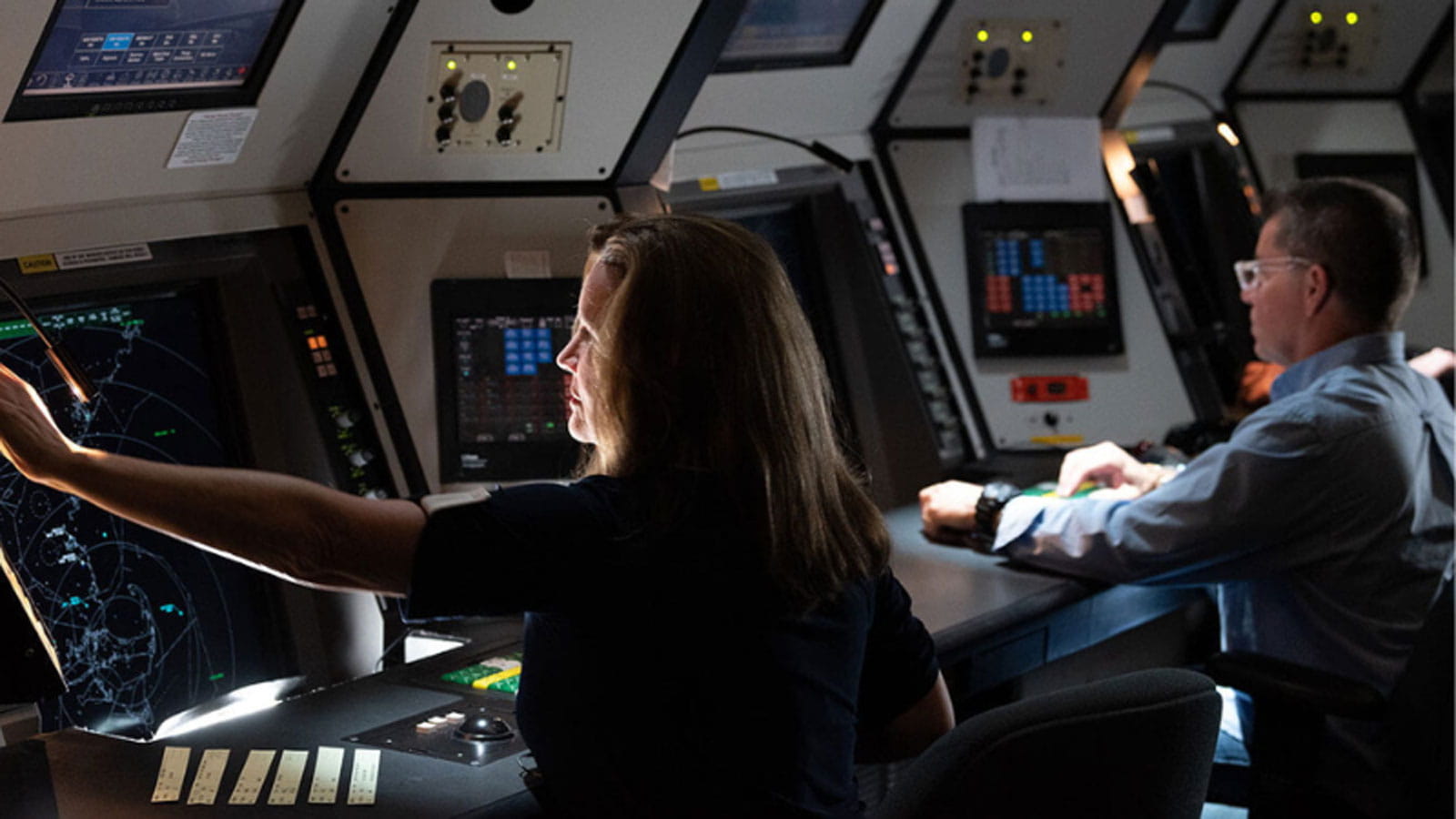 a man and a woman working air traffic control