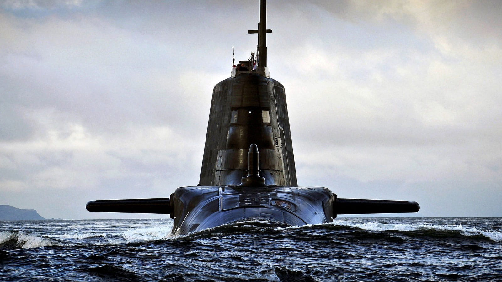 A submarine surfacing above the water
