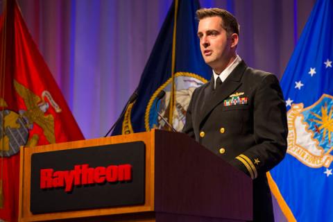 Raytheon employee Chris McLean, a lieutenant in the U.S. Navy Reserve, addresses a crowd of coworkers and guests at a Veterans Day event in El Segundo, California.