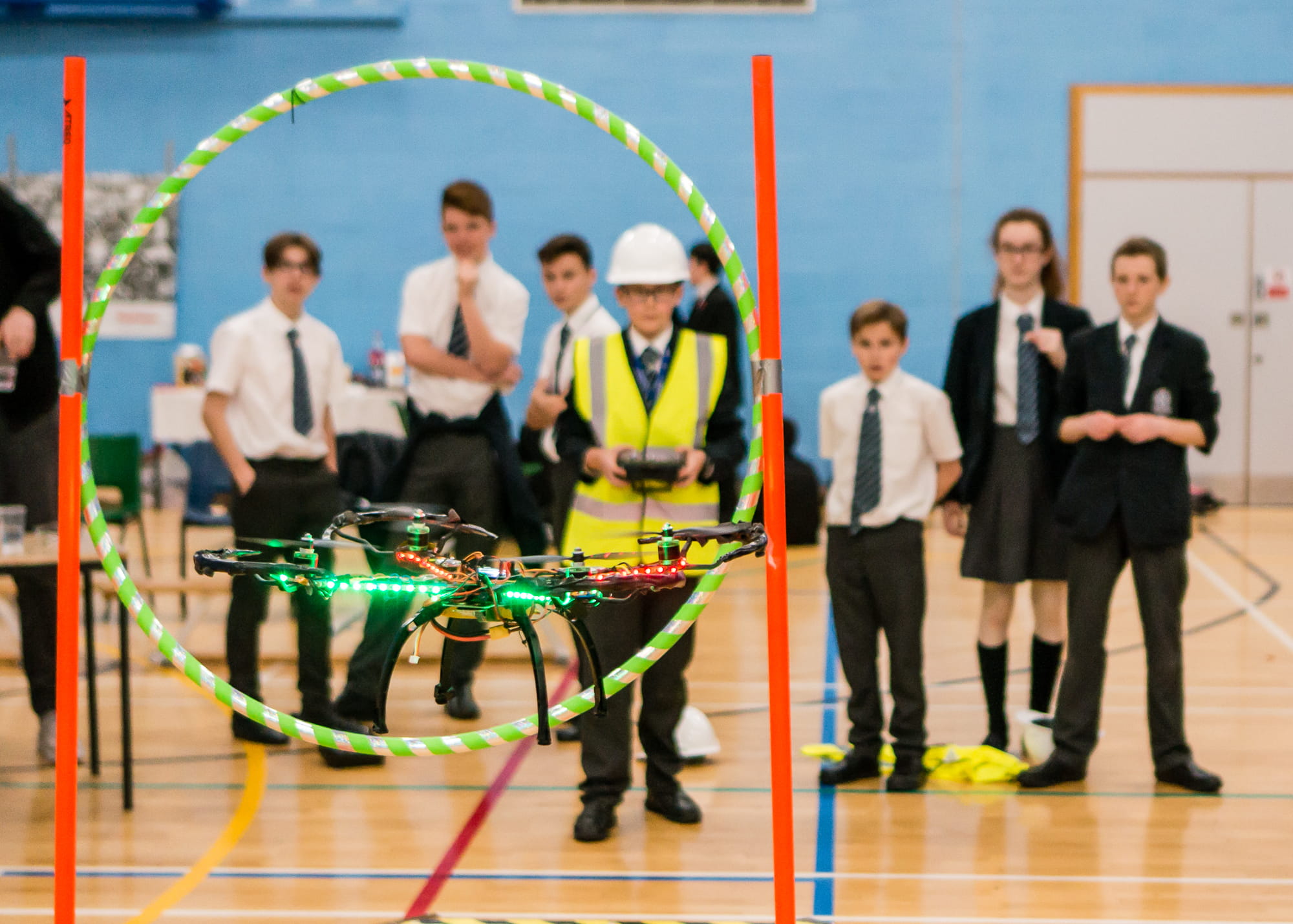 A quadcopter flies through an obstacle at the 2017 Raytheon UK Quadcopter Challenge regional competition. The company hosts the event to promote the interest of young people in science, technology, engineering and math.