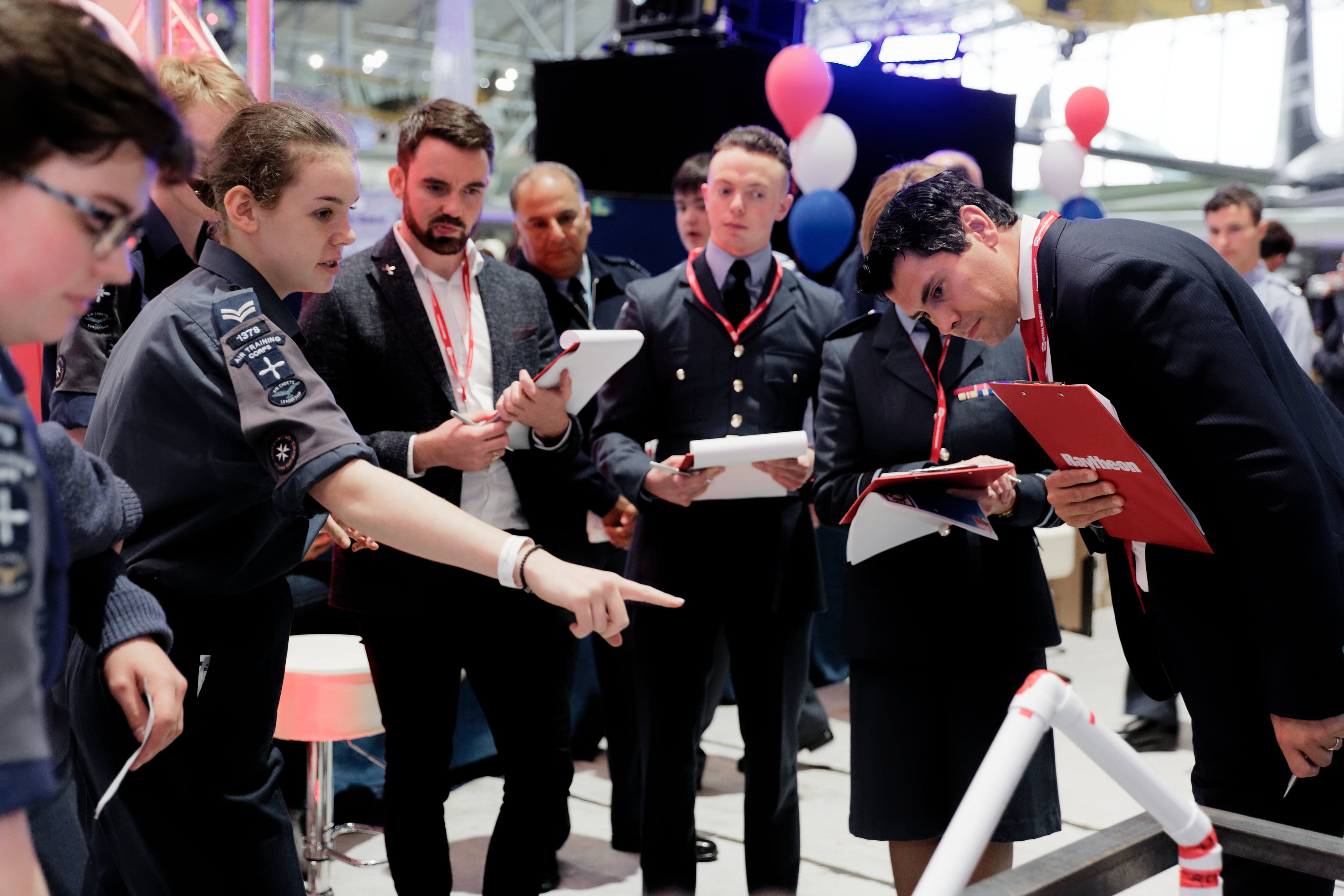 Royal Air Force Engineering Competition contestants discuss their entry with the judge.