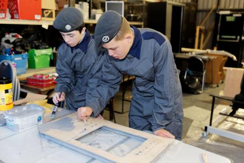Raytheon-mentored cadets work together applying finishing touches to their entry for the Royal Air Force Engineering Competition.